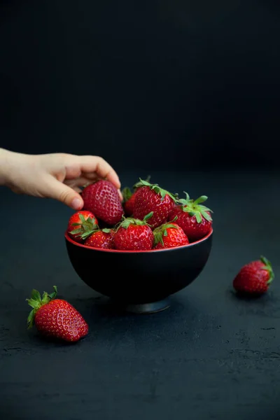 Child Hand Taking Strawberry Bowl Black Background — Stock Photo, Image