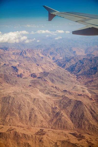 Aerial view from the airplane - Egyptian deserted landscape with mountains.
