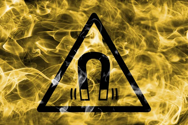 Magnetic field hazard warning smoke sign. Triangular warning hazard sign, smoke background.