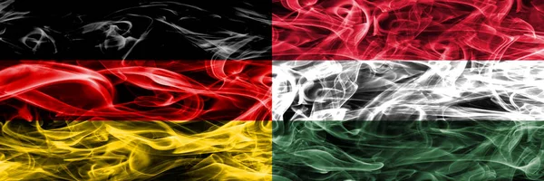 Germany vs Hungary smoke flags placed side by side. German and Hungary flag together