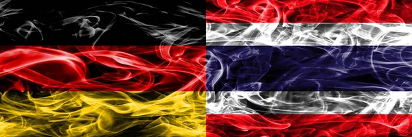 Germany vs Thailand smoke flags placed side by side. German and Thailand flag together