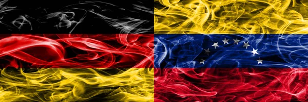 Germany vs Venezuela smoke flags placed side by side. German and Venezuela flag together