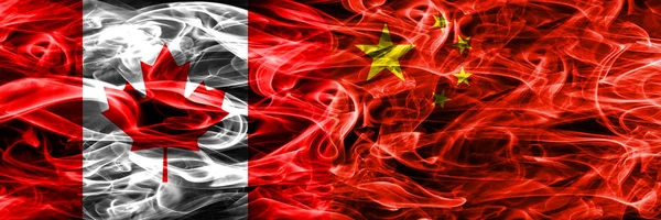 Canada vs China smoke flags placed side by side. Canadian and China flag together