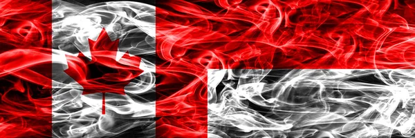 カナダ 並べて煙インドネシア フラグ 一緒にカナダとインドネシアの国旗 — ストック写真