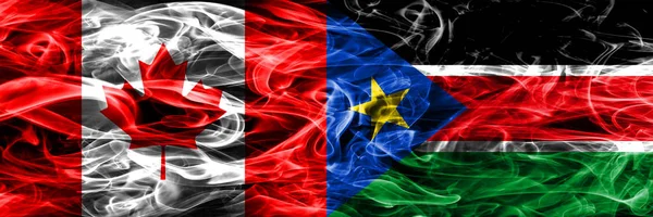 Canada vs South Sudan smoke flags placed side by side. Canadian and South Sudan flag together