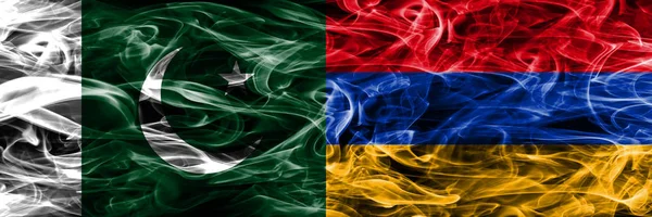 Pakistan vs Armenia smoke flags placed side by side. Thick colored silky smoke flags of Pakistan and Armenia