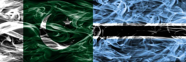 Pakistan vs Botswana smoke flags placed side by side. Thick colored silky smoke flags of Pakistan and Botswana