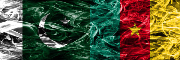Pakistan vs Cameroon smoke flags placed side by side. Thick colored silky smoke flags of Pakistan and Cameroon