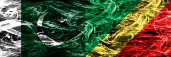 Pakistan vs Congo smoke flags placed side by side. Thick colored silky smoke flags of Pakistan and Congo