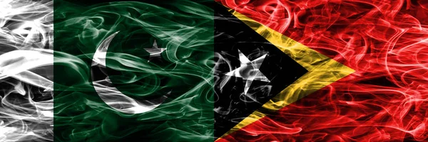 Pakistan vs East Timor smoke flags placed side by side. Thick colored silky smoke flags of Pakistan and East Timor