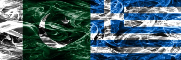 Pakistan vs Greece smoke flags placed side by side. Thick colored silky smoke flags of Pakistan and Greece