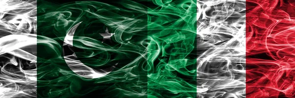 Pakistan vs Italy smoke flags placed side by side. Thick colored silky smoke flags of Pakistan and Italy