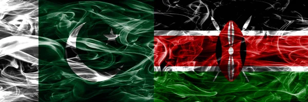 Pakistan vs Kenya smoke flags placed side by side. Thick colored silky smoke flags of Pakistan and Kenya