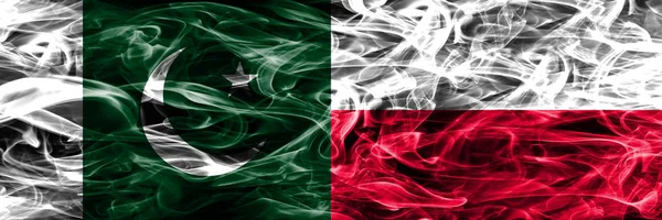 Pakistan vs Poland smoke flags placed side by side. Thick colored silky smoke flags of Pakistan and Poland