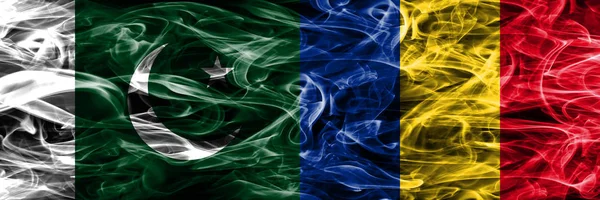 Pakistan vs Romania smoke flags placed side by side. Thick colored silky smoke flags of Pakistan and Romania