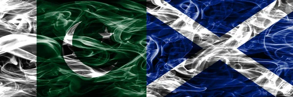 Pakistan vs Scotland smoke flags placed side by side. Thick colored silky smoke flags of Pakistan and Scotland