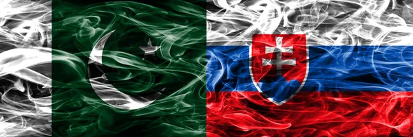 Pakistan vs Slovakia smoke flags placed side by side. Thick colored silky smoke flags of Pakistan and Slovakia