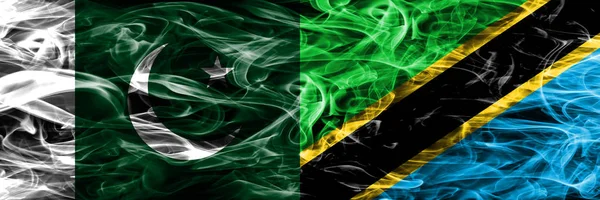 Pakistan vs Tanzania smoke flags placed side by side. Thick colored silky smoke flags of Pakistan and Tanzania