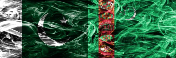 Pakistan vs Turkmenistan smoke flags placed side by side. Thick colored silky smoke flags of Pakistan and Turkmenistan
