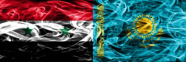 Syria vs Kazakhstan smoke flags placed side by side. Thick colored silky smoke flags of Syrian and Kazakhstan