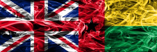 Великобритания Гвинея Бисау Дымовые Флаги Помещены Бок Бок Толстые Шёлковые — стоковое фото
