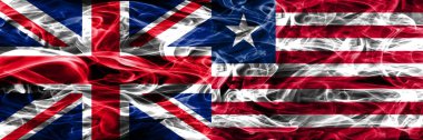 İngiltere vs Liberya duman bayrakları yan yana yerleştirilmiş. Büyük Britanya ve Liberya ipeksi duman bayrakları renkli kalın