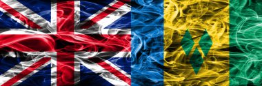 İngiltere vs Saint Vincent ve Grenadinler duman bayrakları yan yana yerleştirilmiş. Büyük Britanya ve Saint Vincent ve Grenadinler ipeksi duman bayrakları renkli kalın