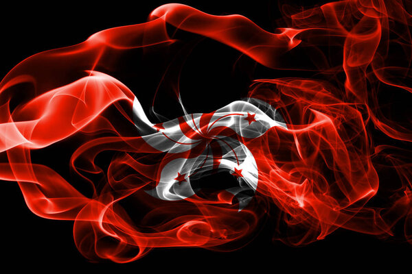 National flag of Hong Kong made from colored smoke isolated on black background. Abstract silky wave background.