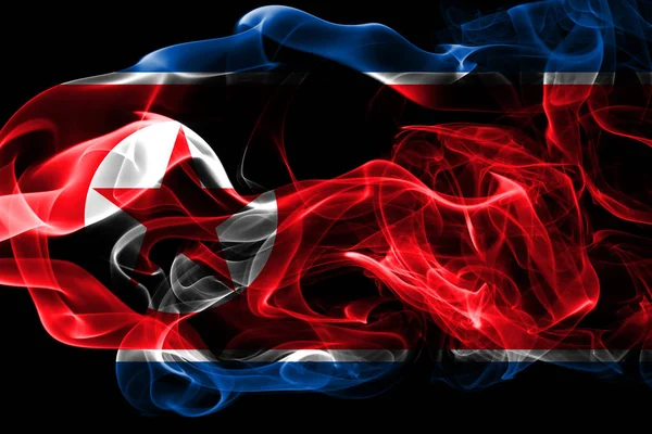 National flag of North Korea made from colored smoke isolated on black background. Abstract silky wave background.