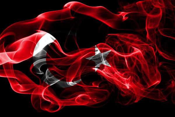National flag of Turkey made from colored smoke isolated on black background. Abstract silky wave background.