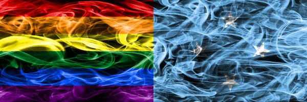 同性恋 密克罗尼西亚烟旗并排放置 同性恋和密克罗尼西亚的厚颜色的丝质烟雾旗 — 图库照片