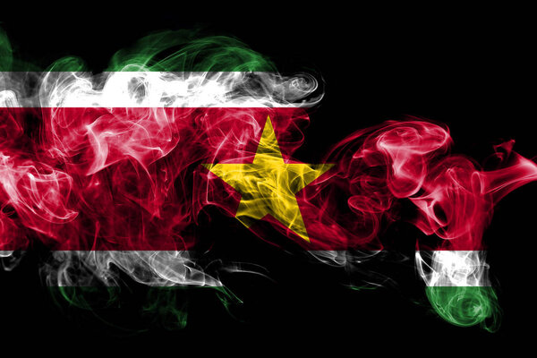 National flag of Suriname made from colored smoke isolated on black background. Abstract silky wave background.