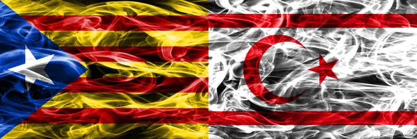 Catalonia vs Northern Cyprus copy smoke flags placed side by side. Thick colored silky smoke flags of Catalan and Northern Cyprus copy