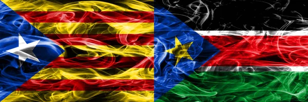 Catalonia vs South Sudan copy smoke flags placed side by side. Thick colored silky smoke flags of Catalan and South Sudan copy