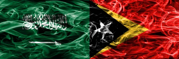 Саудовская Аравия Против Восточного Тимора Флаги Дыма Помещены Бок Бок — стоковое фото