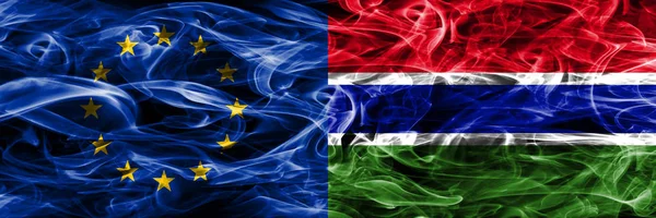 Europe Union and Gambia colorful concept smoke flags placed side by side