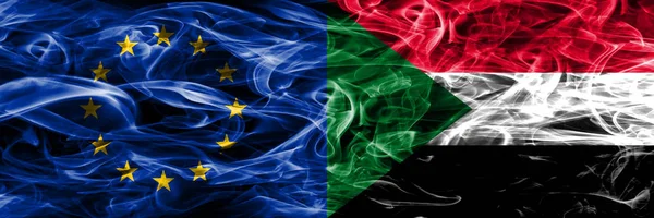 Europe Union and Sudan colorful concept smoke flags placed side by side