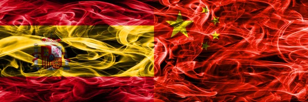 Spain vs China smoke flags placed side by side. Thick colored silky smoke flags of Spanish and China