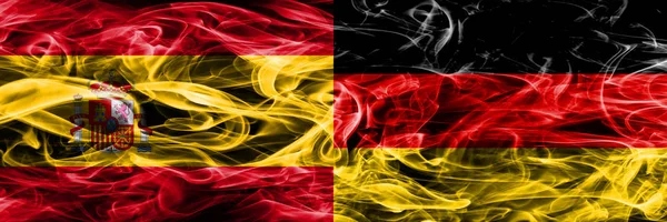 Spain vs Germany smoke flags placed side by side. Thick colored silky smoke flags of Spanish and Germany