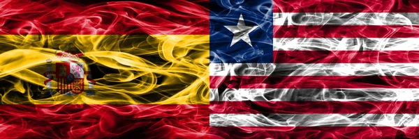 Испания Против Либерии Дымовые Флаги Размещенные Бок Бок Толстые Шёлковые — стоковое фото