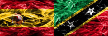 İspanya – Saint Kitts ve Nevis bayrakları yan yana yerleştirilmiş duman. İspanyolca ve Saint Kitts ve Nevis ipeksi duman bayrakları renkli kalın