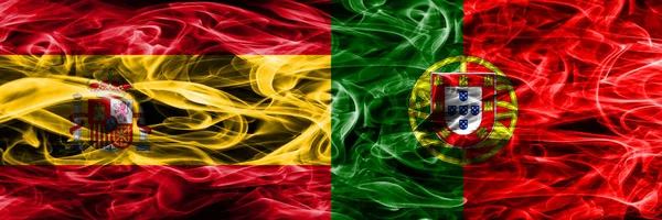 西班牙 葡萄牙烟旗并排放置 西班牙和葡萄牙厚颜色的丝质烟雾旗 — 图库照片