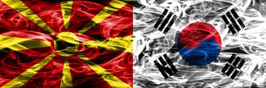 Makedonya vs Güney Kore renkli kavramı duman bayrakları yan yana yerleştirilmiş