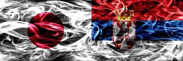 Японія Проти Сербії Сербська Дим Прапори Розміщені Поруч — стокове фото