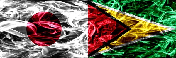 Япония Против Гайаны Гайанские Дымовые Флаги Размещенные Бок Бок — стоковое фото
