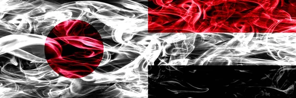 日与也门 也门烟旗并排放置 — 图库照片