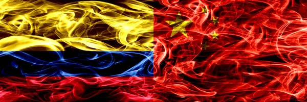 Colombia vs China, Chinese smoke flags placed side by side. Thick colored silky smoke flags of Colombian and China, Chinese