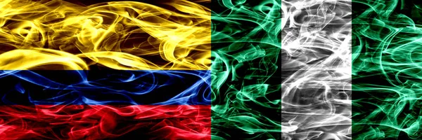Colombia vs Nigeria, Nigerian smoke flags placed side by side. Thick colored silky smoke flags of Colombian and Nigeria, Nigerian