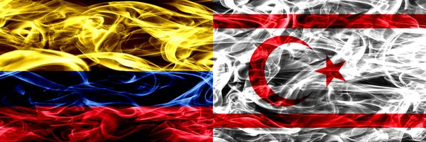 Colombia vs Northern Cyprus smoke flags placed side by side. Thick colored silky smoke flags of Colombian and Northern Cyprus