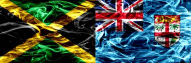 Jamaika vs Fiji duman bayrakları yan yana yerleştirilmiş. Jamaika ve Fiji ipeksi duman bayrakları renkli kalın